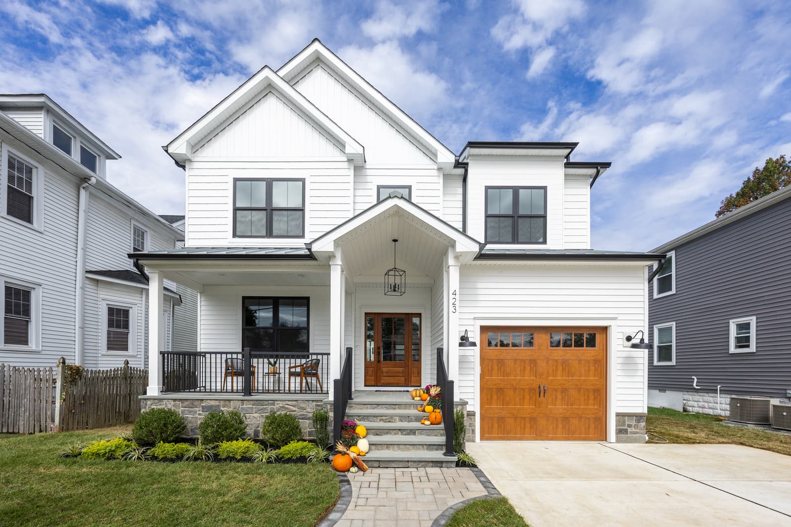 Farmhouse-style home exterior with a cedar garage door in Haddon Township, NJ