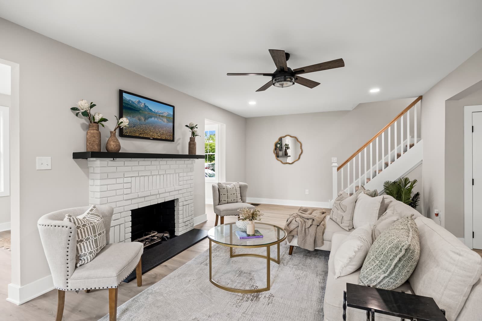 Living room with a white brick fireplace and staircase in Haddon Township, NJ