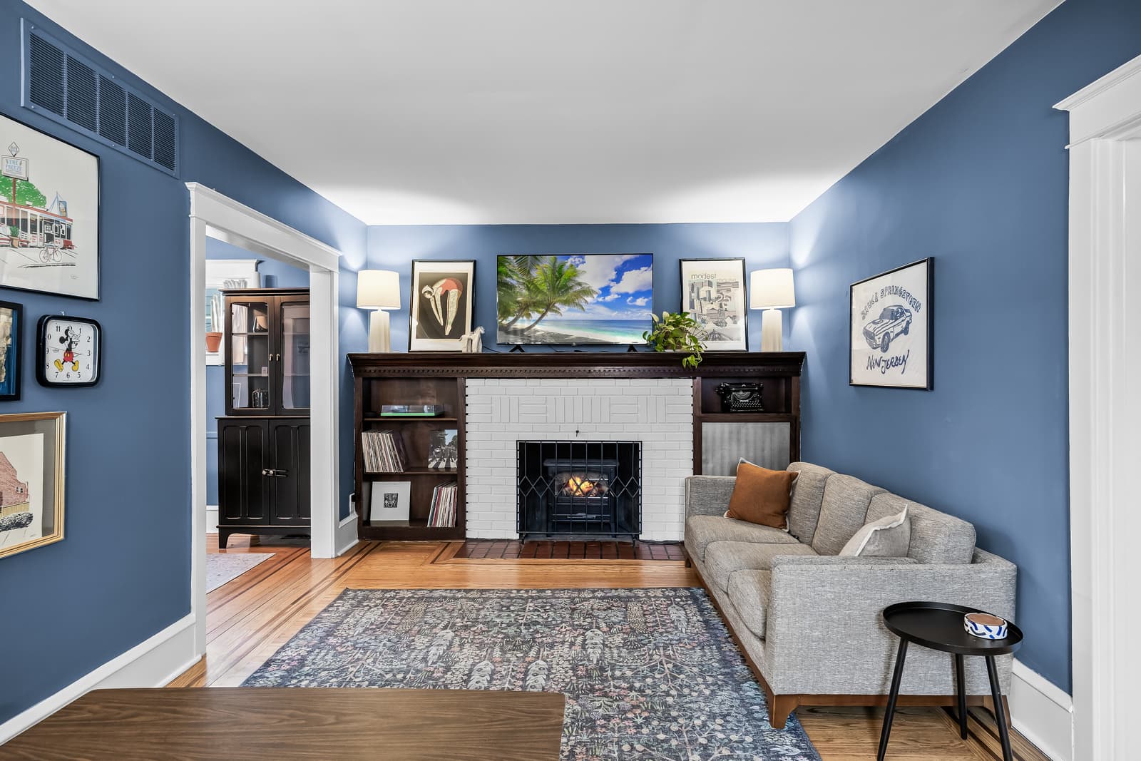 Living room with a navy accent wall and fireplace in Haddon Township, NJ