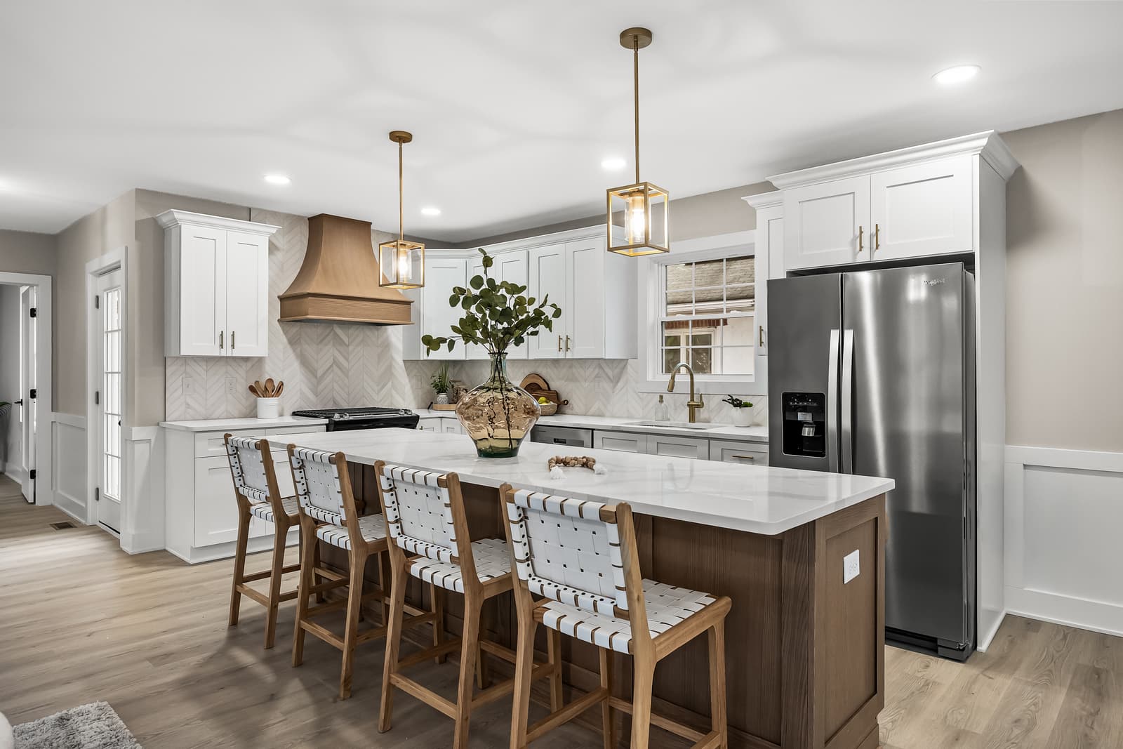 White kitchen with a wood island and pendant lighting in Haddon Township, NJ